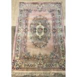 A Chinese washed wool pink ground carpet of typical design, 300cm x 183cm