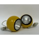 A pair of yellow 1960s style aluminium ball form theatre lights (diameter- 19cm)