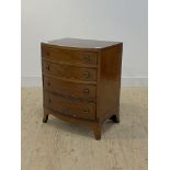 An Edwardian mahogany bow front chest, with satinwood cross band over four graduated drawers, raised