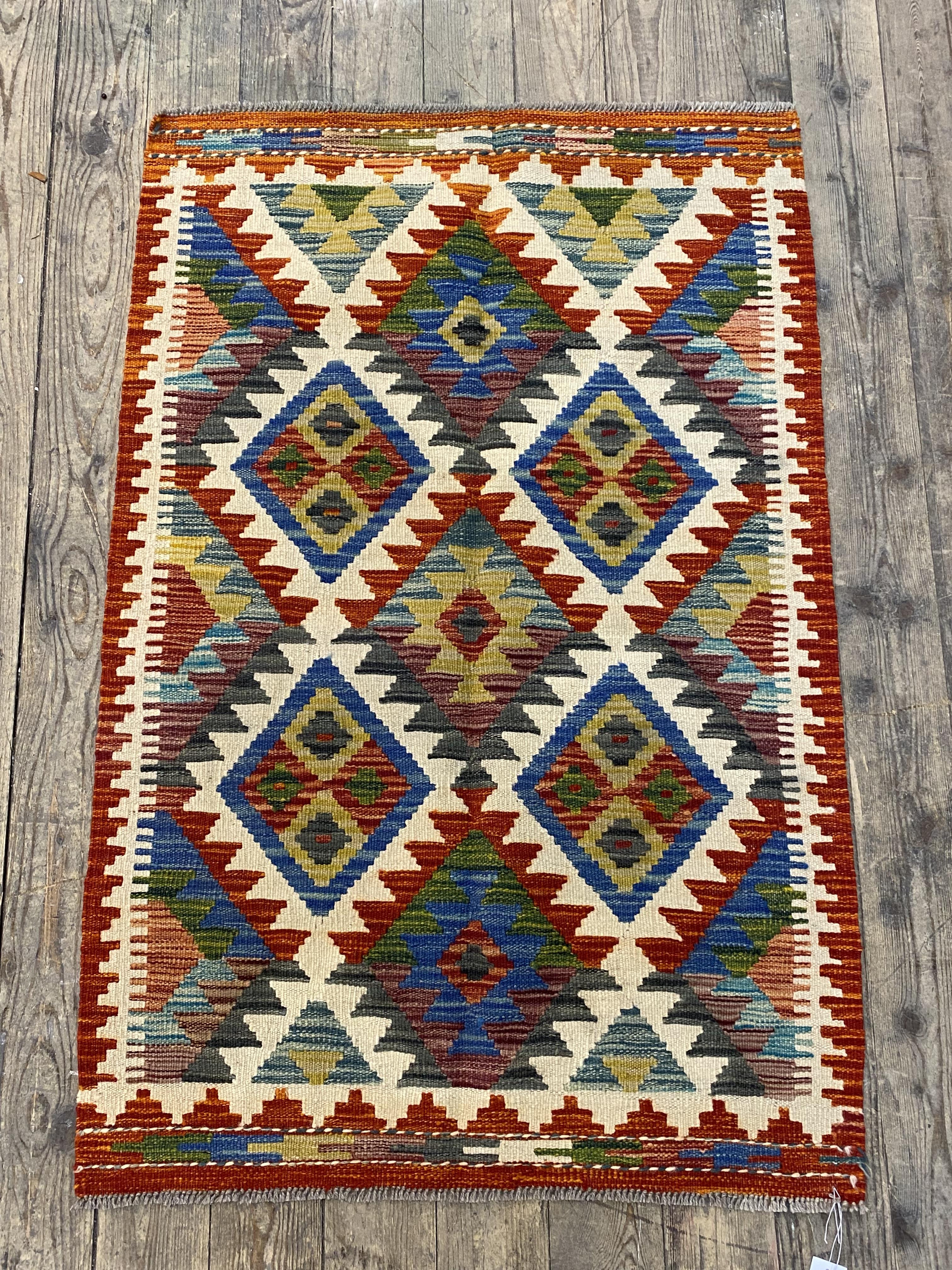 A Chobi Kilim rug of typical design 124cm x 80cm