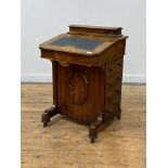 A Victorian well figured walnut and marquetry davenport, the top fitted with a hinged stationary