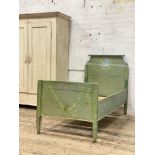 A 19th century French turquoise painted oak and pine single bed, the head and footboard painted with