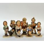 A group of seven Hummel figures comprising "Little Scholar" (h- 15.5cm), "Apple Tree Boy", "Happy