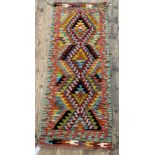 A Chobi Kilim runner rug of geometric design 154cm x 61cm