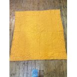 A vintage 1920s / 30s square shaped golden orange coloured double sided quilt with centre