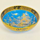 A Carlton Ware bowl decorated with Oriental scene with pagodas and figure, on blue ground, with