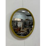 A contemporary circular wall mirror in a mustard coloured frame D55cm