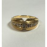 An 18ct gold shaped diamond half eternity style graduated ring set thirteen graduated diamonds in