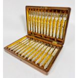 An Edwardian Epns set of twelve pairs of fish knives and forks with beaded handles and engraved