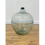 A large green glass carboy with rubber bung, H54cm