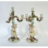 A pair of five light (loss to one) Dreseden porcelain candelabra decorated with rose and foliage