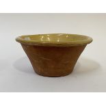 A 19th century slipware dairy bowl, of tapered cylindrical form H15cm, D33cm