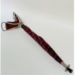 A featherweight aluminum shooting stick with leather seat and tartan umbrella, with a spike base