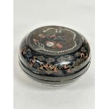 A Chinese black lacquered 1900/1920s circular storage box decorated with five claw dragon chasing
