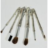 A group of six white metal handled make up brushes with fur tipped ends and eyebrow brush, (L: 17cm,
