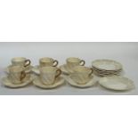 A set of Coalport cream coloured teacups and saucers comprising six gilt handled cups (chipped,