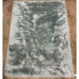 A contemporary vintage style deep pile turquoise rug, 345cm x 245cm