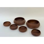 A collection of handmade Thai teak wooden bowls, comprising four snack bowls ( h- 6cm w- 14.5cm) and