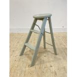 An early 20th century green painted hardwood folding stool step ladder, makers badge inscribed