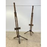 A matched pair of mid century beech and pine folding artists easels, each on three splayed supports