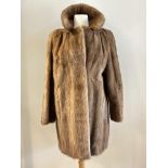 A lady's ranch mink 3/4 length jacket complete with collar and satinised lining, inner tie, slash