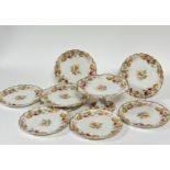 A Limoges eight piece dessert set by Goa with transfer printed rose patterned scalloped plates, (