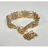A 9ct gold gate link bracelet complete with heart shaped padlock and safety chain, (excluding