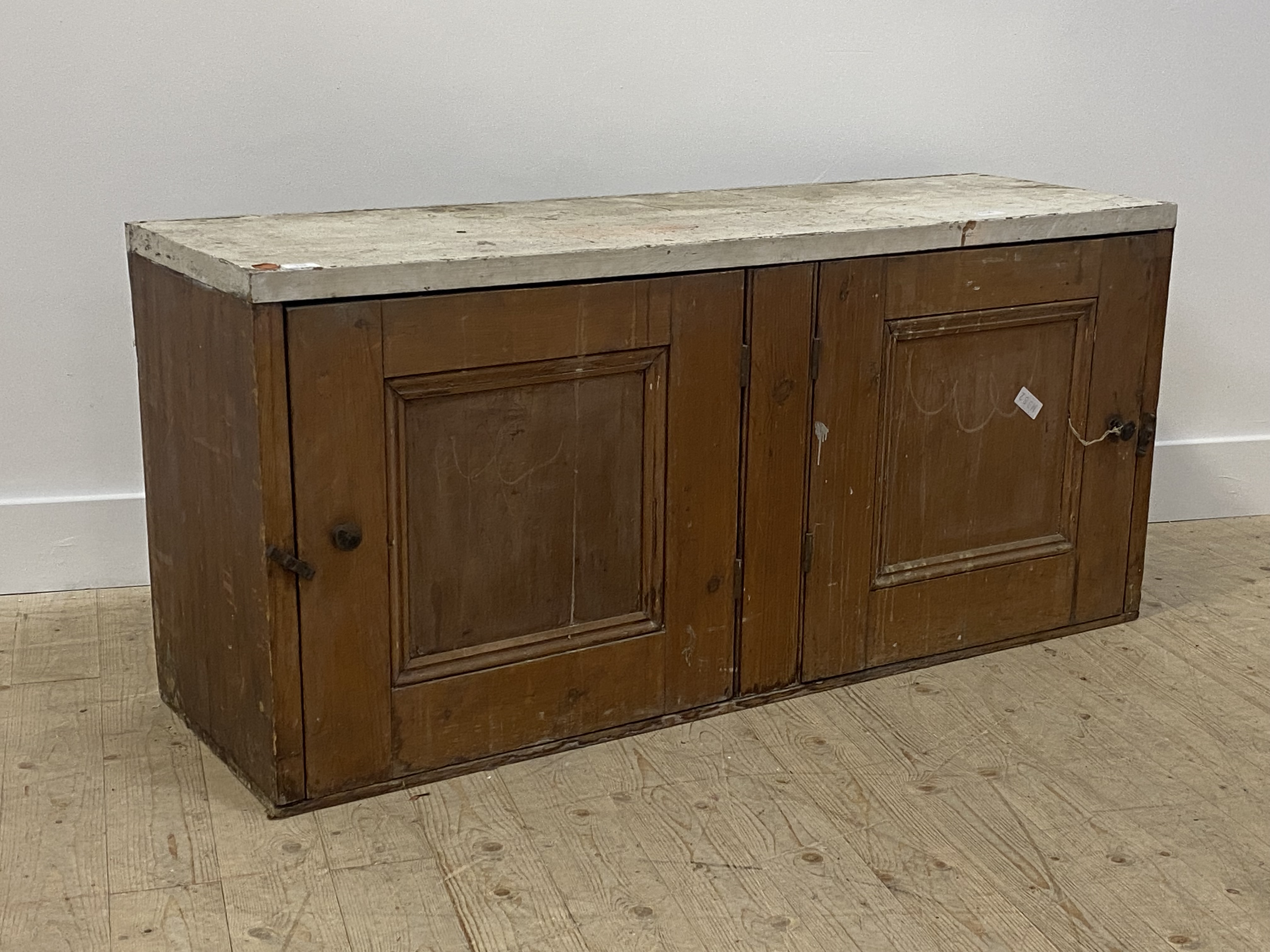 A late 19th century pine side cabinet, the white painted top over two panelled doors H64cm,