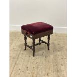 A late Victorian mahogany rise and fall music stool, the red velvet upholstered seat raised on