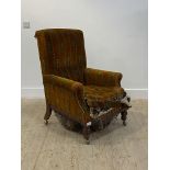 A Victorian walnut framed armchair, raised on turned supports and later castors (A/F) H101cm