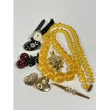 A plastic amber coloured graduated 1920s / 30s bead necklace, (L: 39cm) a cherry paste set drop