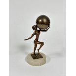 A World Framed Ingots spelter figure holding a globe with hinged top enclosing a lighter on circular