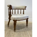 A Victorian oak framed tub chair, the back rest on a spindle gallery with scroll carved terminals