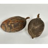 Aboriginal School, Two Seed Pods, engraved with chisel style snakes, lizards and kangaroo and figure