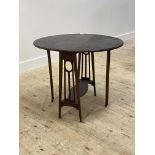 An early 20th century mahogany drop leaf table, the oval top raised on square tapered supports