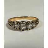 An Edwardian yellow metal ring set five graduated old mine cut stones, largest approximately 0.
