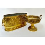 A brass trough/planter and liner with heraldic design in relief and lion's head/loop handles (h-