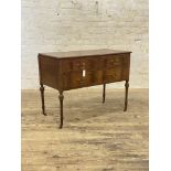 An Edwardian mahogany side table, the rectangular top over two short and three long drawers,