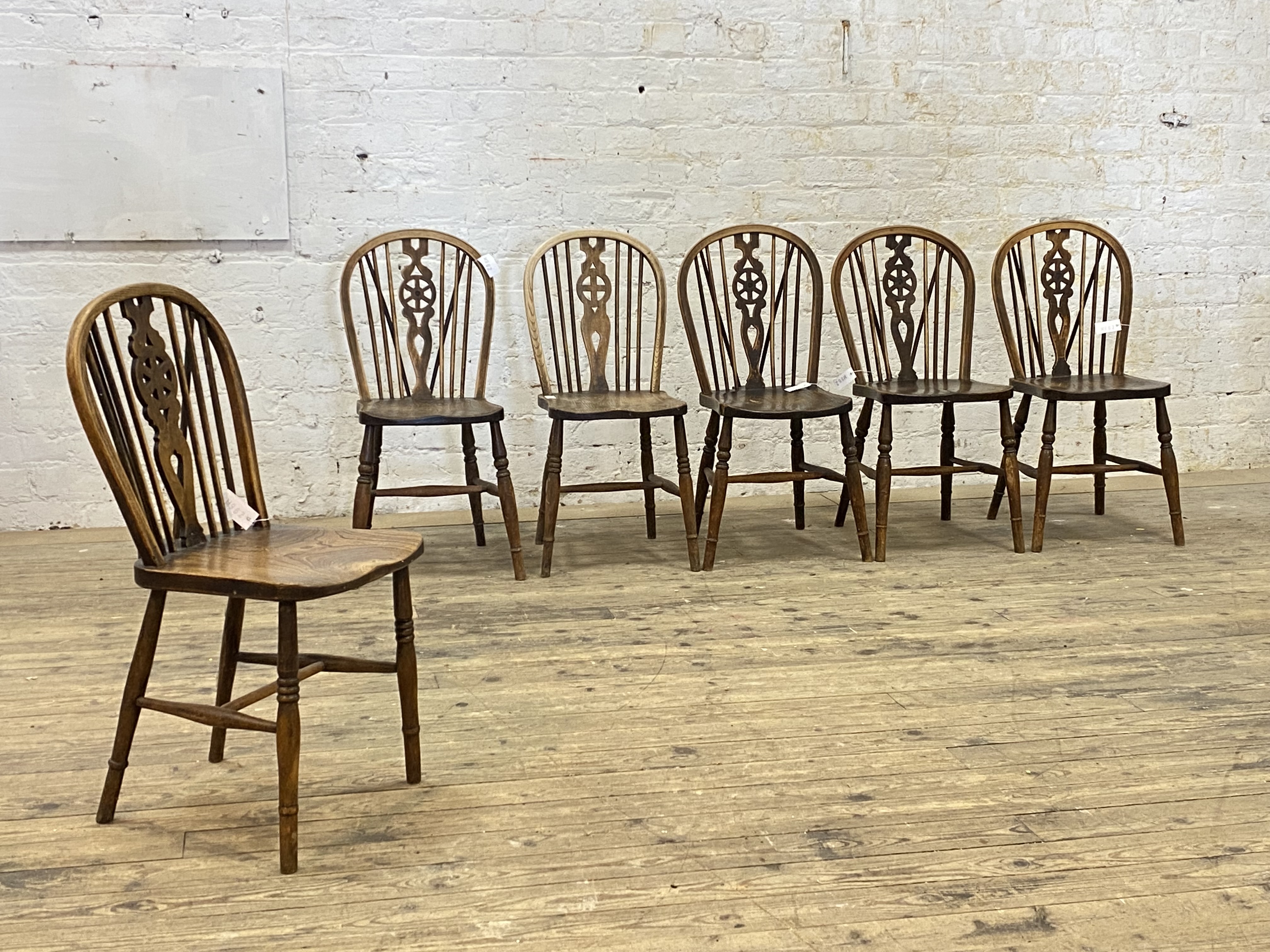 A set of six 19th century elm and ash Windsor dining chairs, hoop spindle and splat carved wheel