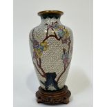 A modern Chinese cloisonne enamel vase with decoration of prunus blossoms and a butterfly amidst