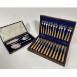 Twelve pairs of Epns fish knives and forks with early plastic handles with silver mounted 1919
