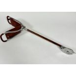 A Gamebird aluminum leather mounted shooting stick with fold down top with leather padded seat, on