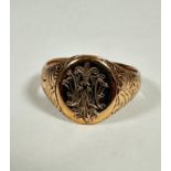 A gentleman's engraved signet ring, the oval plaque with engraved initials WJW, (W/X) (7.44g) a