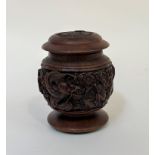 A wooden tobacco jar in carved relief depicting dragons and monkeys and an army emblem to cover. (h-