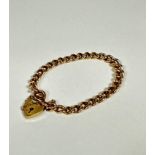 A 9ct gold curb link bracelet complete with 9ct gold heart shaped padlock and safety chain, (d: 8cm)