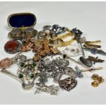 A collection of costume and metal jewellery including a paste set circular open brooch, a white