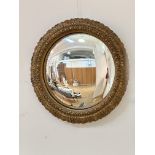 A gilt circular plaster convex mirror with moulded acanthus leaf and beaded border, (d: 55cm)