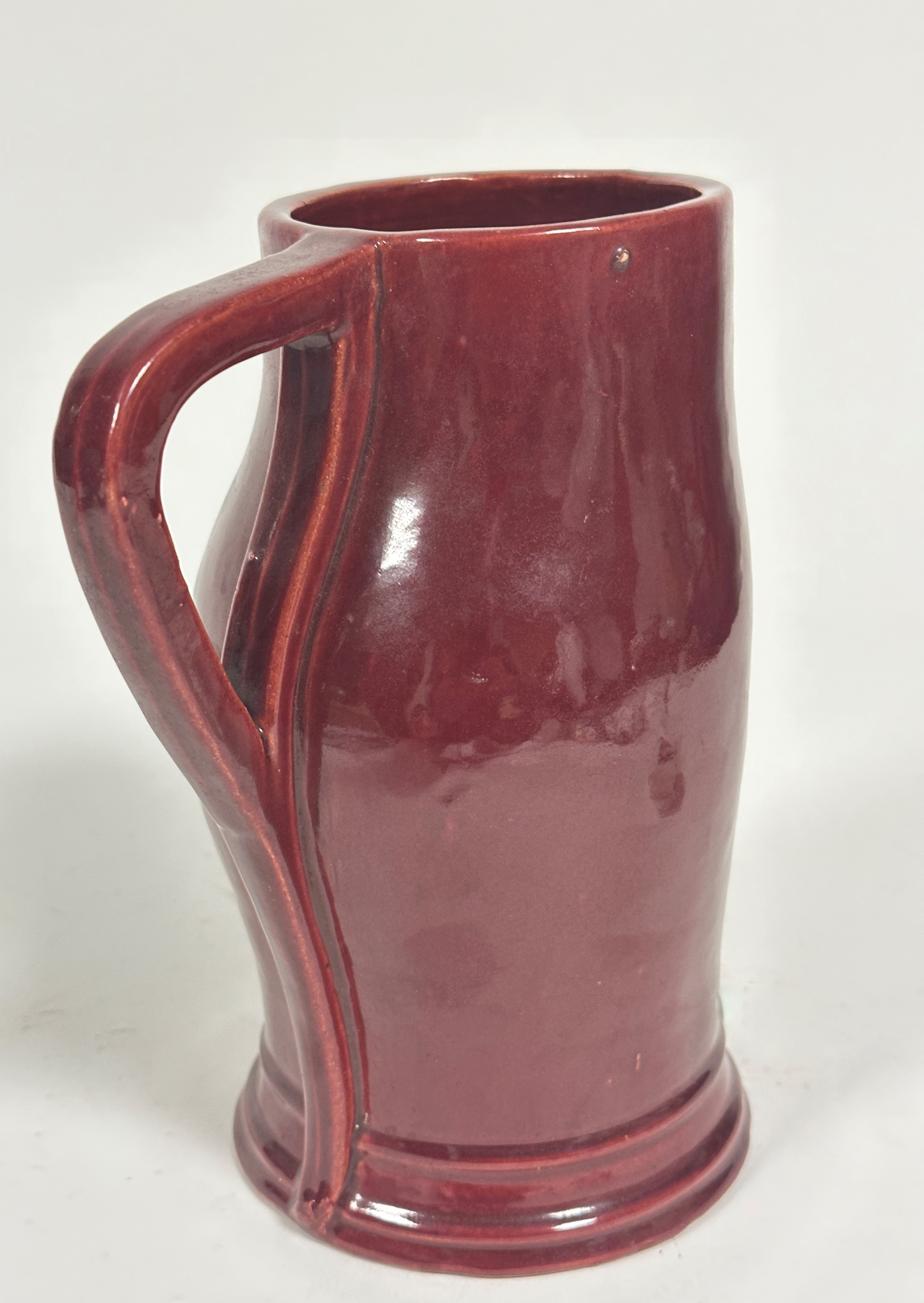 A Dunmore moulded shaped tankard of sculpted form with shaped handle to side and embossed centre - Image 2 of 3