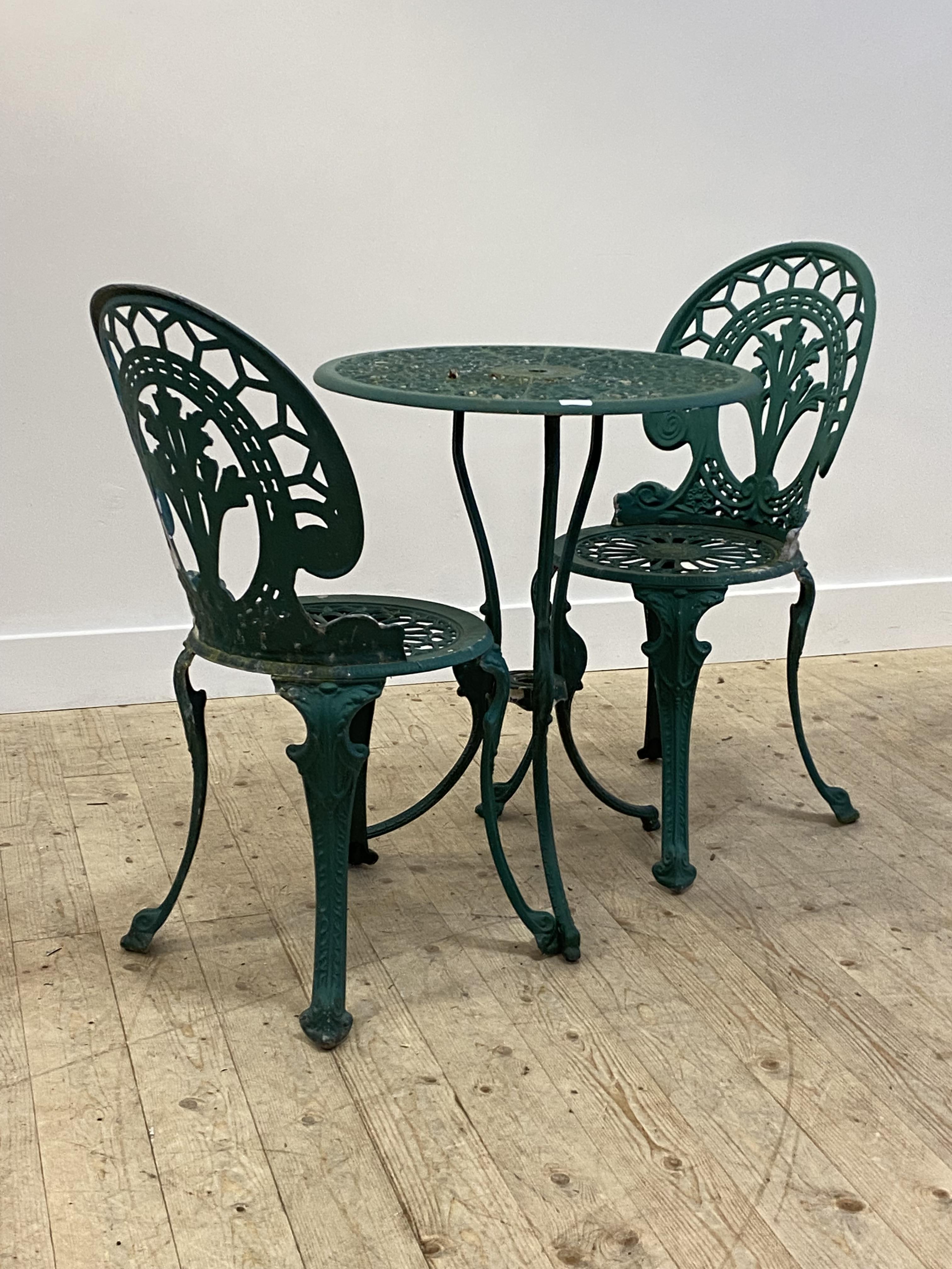 A green painted cast aluminium garden table (H74cm, D61cm) and a pair of matching chairs