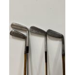 A group of four vintage golf clubs with wooden/steel shafts comprising a Forgan St Andrews Gold